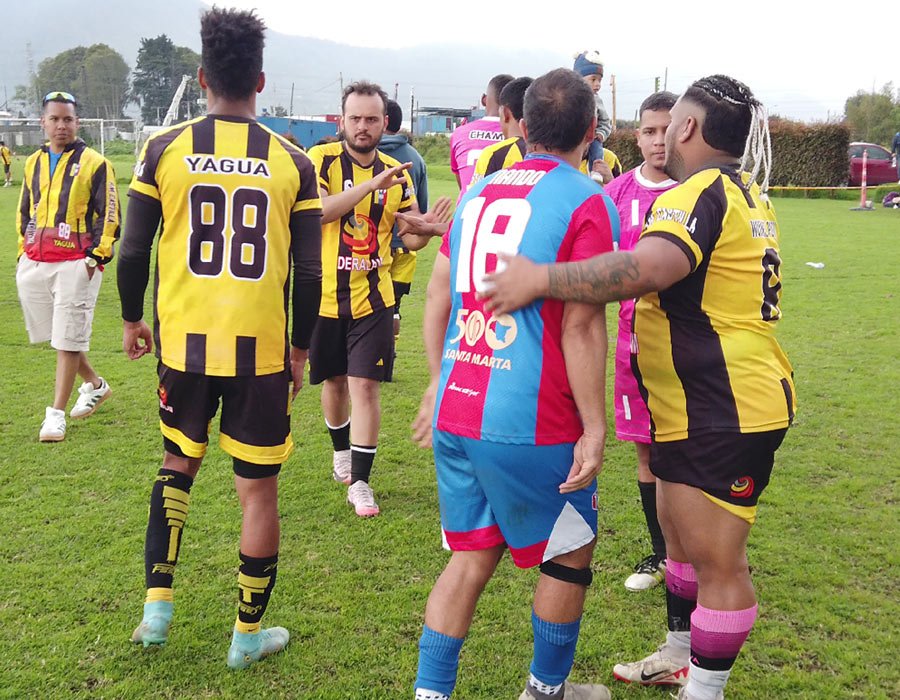 Jugadores salduandose en torneo de fútbol 8 en Bogotá